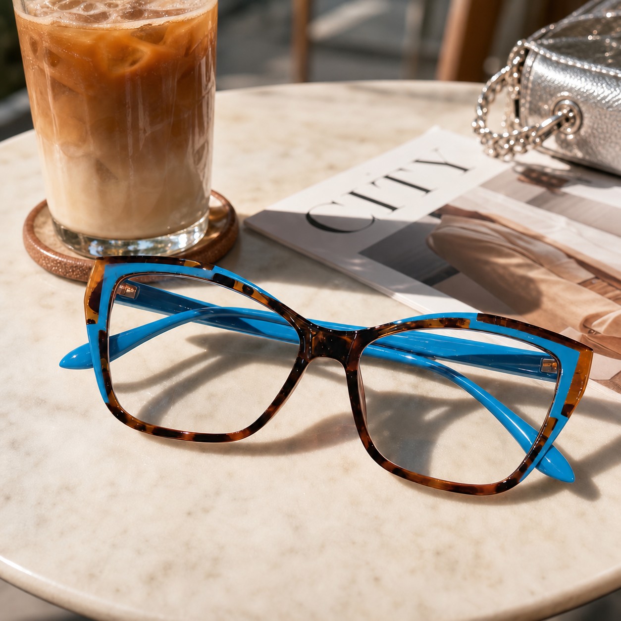 Blue and tortoiseshell frames on a cafe table